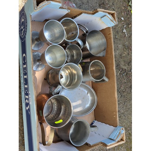 177 - A group of metal tavern and kitchen wares, including pewter goblets and mugs, a lidded tankard, grad... 