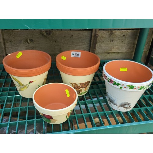 179 - Four painted terracotta flowerpots.