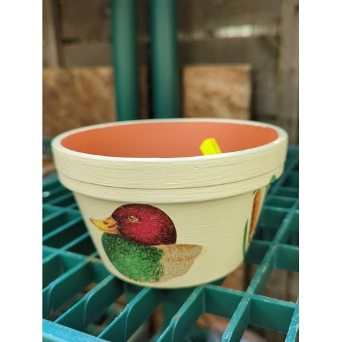 179 - Four painted terracotta flowerpots.