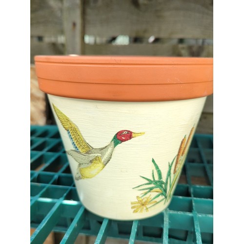 179 - Four painted terracotta flowerpots.