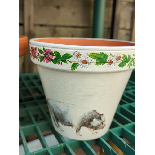 179 - Four painted terracotta flowerpots.