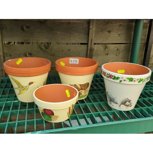 179 - Four painted terracotta flowerpots.
