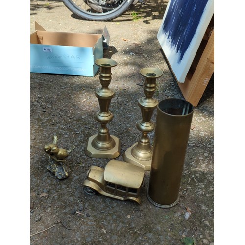 181 - A group of brass decorative objects comprising a pair of stepped candlesticks on octagonal bases, a ... 