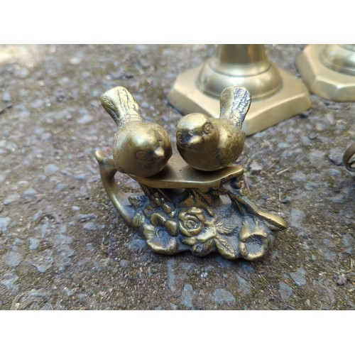 181 - A group of brass decorative objects comprising a pair of stepped candlesticks on octagonal bases, a ... 