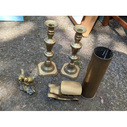 181 - A group of brass decorative objects comprising a pair of stepped candlesticks on octagonal bases, a ... 
