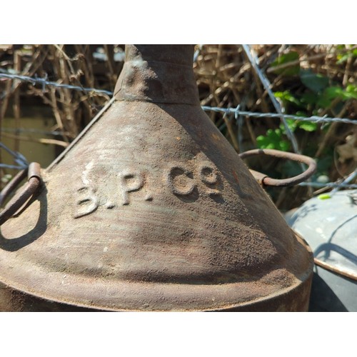 183 - A group of industrial metal containers and automobilia, including an embossed B.P. can, a galvanised... 