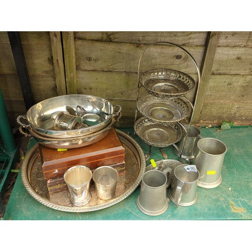 185 - A group of tablewares including an engraved oval tray, twin-handled bowl with assorted flatware, thr... 