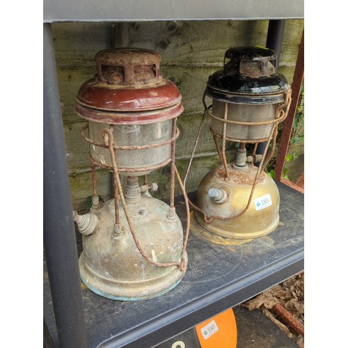 189 - A pair of pressure lanterns, mid-20th century, each with enamelled metal hood above a cylindrical gl... 
