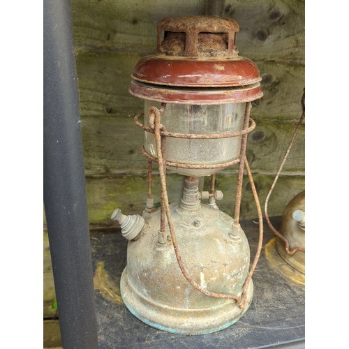 189 - A pair of pressure lanterns, mid-20th century, each with enamelled metal hood above a cylindrical gl... 