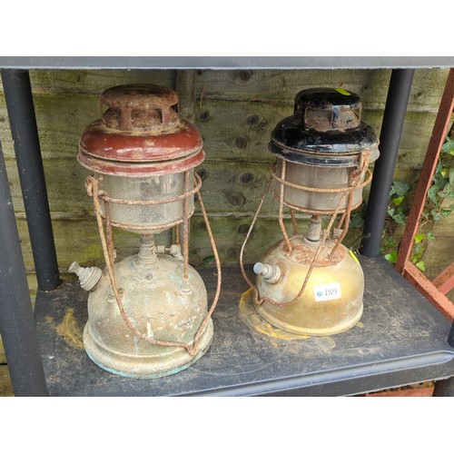 189 - A pair of pressure lanterns, mid-20th century, each with enamelled metal hood above a cylindrical gl... 