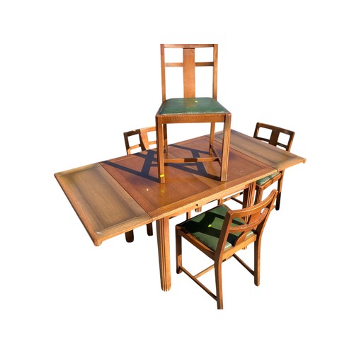 246 - Mid-Century extending dining table with 4 matching green leather topped chairs.