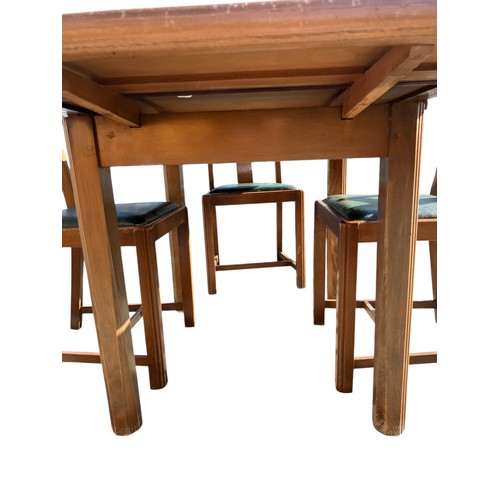 246 - Mid-Century extending dining table with 4 matching green leather topped chairs.