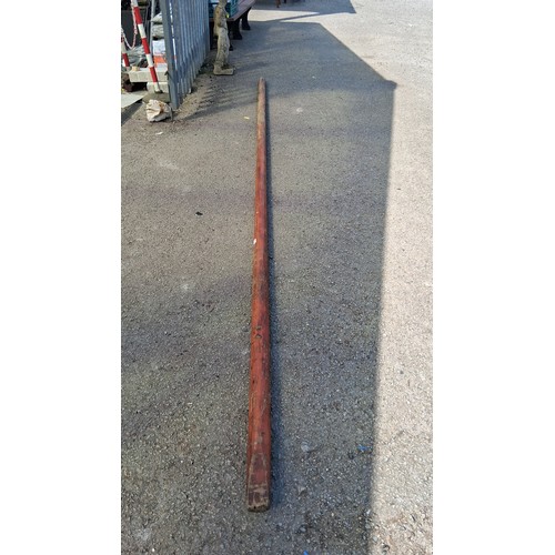 198 - An antique wooden mast.