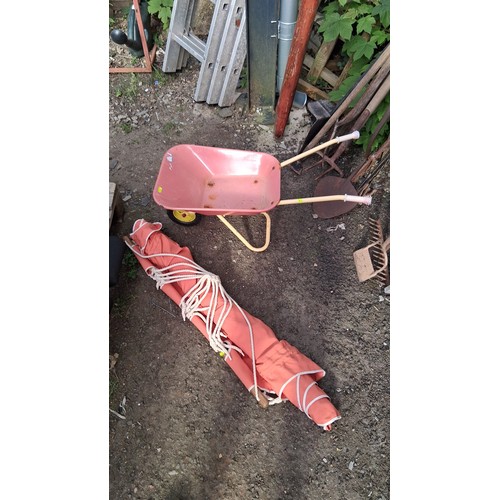202 - A painted child's wheelbarrow, together with an red canvas hammock with wooden spreader bars, braide... 