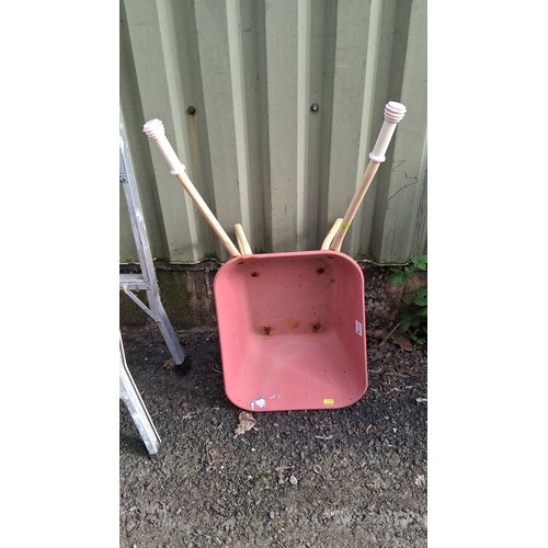 202 - A painted child's wheelbarrow, together with an red canvas hammock with wooden spreader bars, braide... 