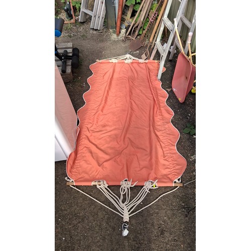 202 - A painted child's wheelbarrow, together with an red canvas hammock with wooden spreader bars, braide... 