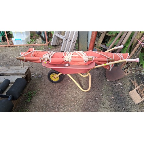 202 - A painted child's wheelbarrow, together with an red canvas hammock with wooden spreader bars, braide... 