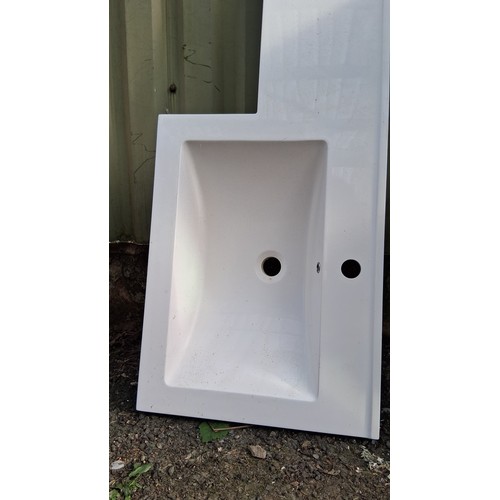 203 - Modern L-shaped white vanity top, with integrated  basin, central waste aperture, and pre-drilled ta... 