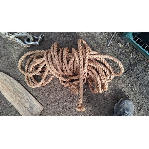204 - A group of nautical equipment comprising a wooden paddle, coiled rope, and two braided mooring lines... 