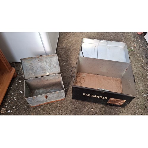 206 - Two galvanised steel storage chests, one painted black and stencilled ‘F.W. ARNOLD’.