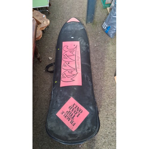 211 - Surfboard with thruster fin set-up and red leash, in a black zippered board bag.