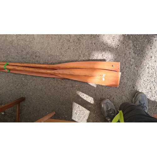 221 - A pair of wooden oars, together with manual rudder.