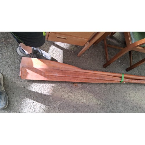 221 - A pair of wooden oars, together with manual rudder.