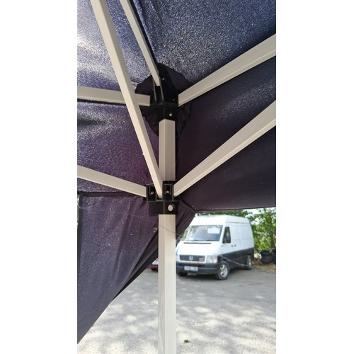 226 - Collapsible pop-up gazebo with navy polyester canopy and white metal scissor-frame supports; shown a... 