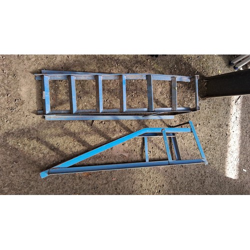 228 - A pair of blue-painted steel loading ramps, stencilled with safe working load 2000 lbs and maker’s d... 