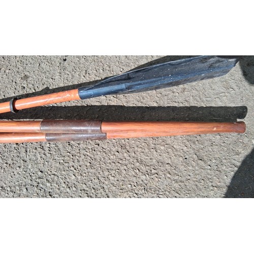231 - 3 canoe or kayak paddles, 2 with wooden shafts and 1 double plastic blade.