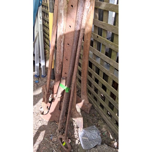234 - A quantity of iron and wooden-handled agricultural and builders’ tools, including a screw press clam... 