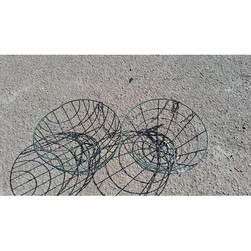 238B - A pair of green-painted wirework hanging basket planters.