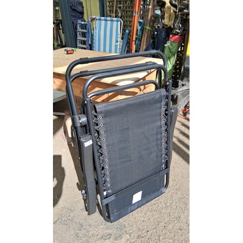 239 - Raxter gravity recliner chair, and removable plastic tray with twin cupholders and compartments, mod... 