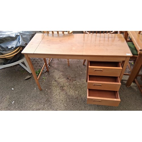 244 - Mid-Century modern teak writing desk, fitted with three drawers.