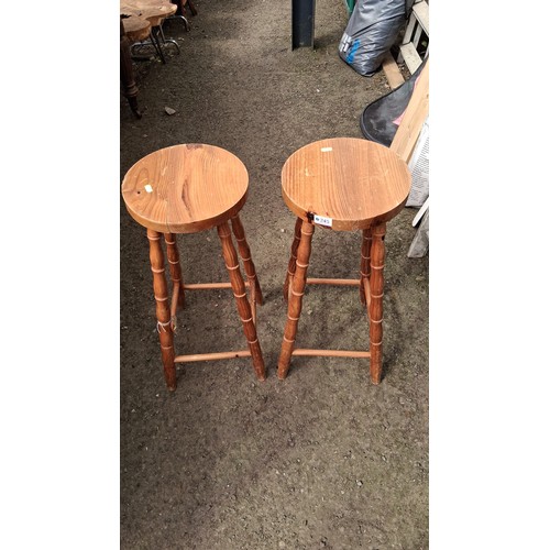 245 - A pair of turned pine bar stools.