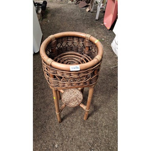 247A - A rattan and wicker jardinière stand.