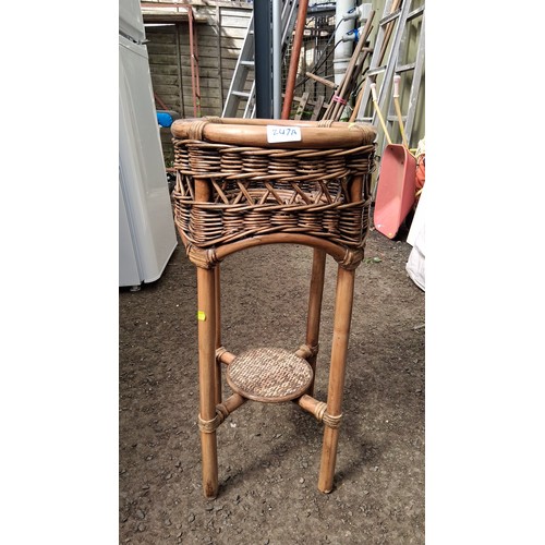 247A - A rattan and wicker jardinière stand.