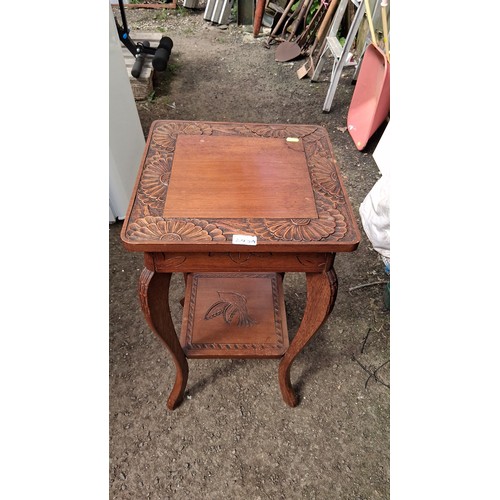248A - 20th century carved oak occasional table, with bold floral relief border and an undertier carved wit... 