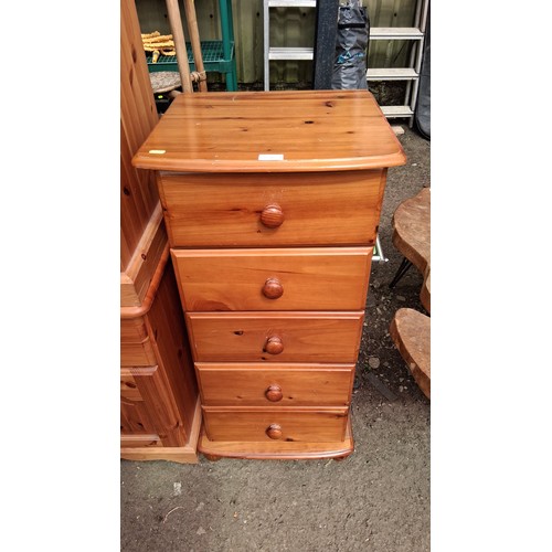250D - Pine tallboy with five graduated drawers, each fitted with a turned knob, raised on a moulded plinth... 