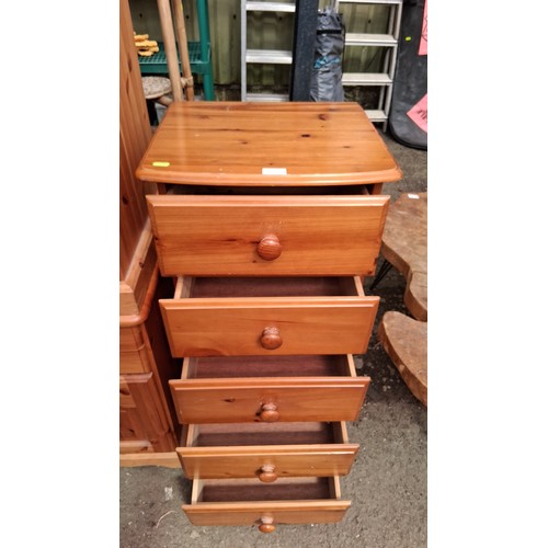 250D - Pine tallboy with five graduated drawers, each fitted with a turned knob, raised on a moulded plinth... 