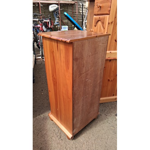 250D - Pine tallboy with five graduated drawers, each fitted with a turned knob, raised on a moulded plinth... 
