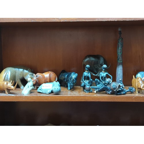 869 - A quantity of carved animal models and figural groups, including elephants, rhinoceros, hippopotamus... 