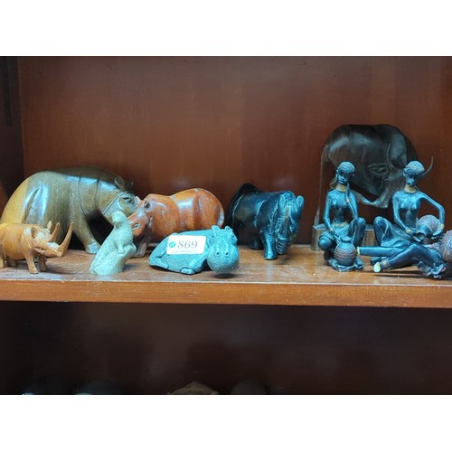 869 - A quantity of carved animal models and figural groups, including elephants, rhinoceros, hippopotamus... 