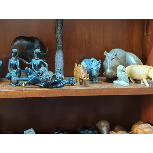 869 - A quantity of carved animal models and figural groups, including elephants, rhinoceros, hippopotamus... 