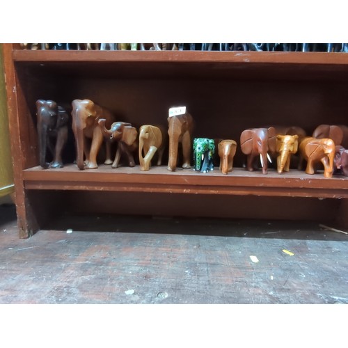 871 - A quantity of carved elephant figures, various sizes and timbers, including examples with painted de... 