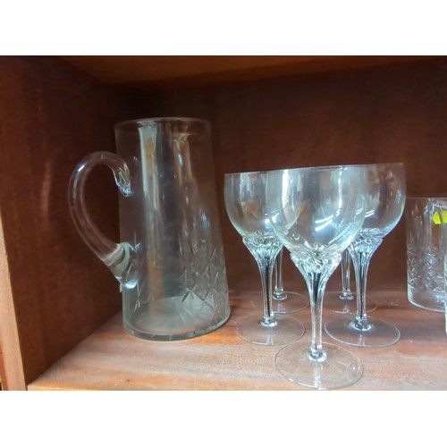 874 - A quantity of cut-glass tablewares including a decanter with faceted stopper, a glass jug, and assor... 