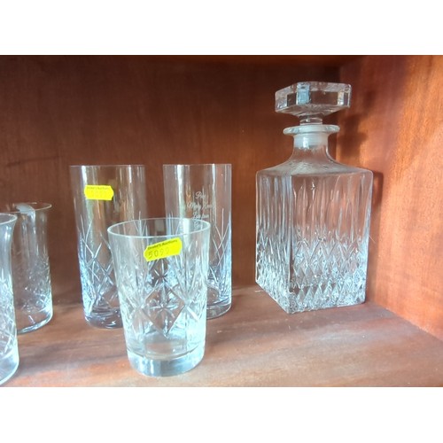 874 - A quantity of cut-glass tablewares including a decanter with faceted stopper, a glass jug, and assor... 