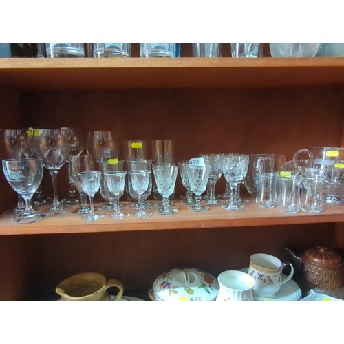 876 - A quantity of mixed table glass, including stemware and tumblers, some wheel-engraved and cut with c... 