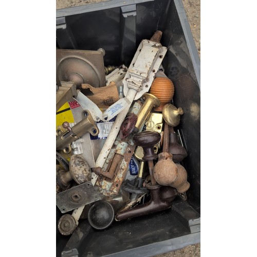 244b - A quantity of mixed door and cabinet hardware, including brass and iron pull handles, escutcheons, r... 