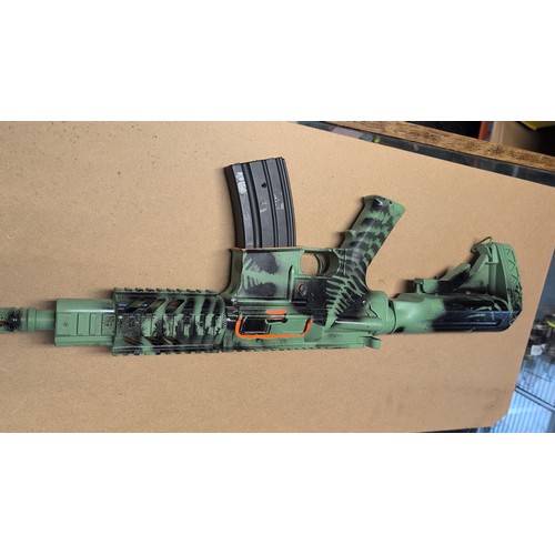 599 - AR-style airsoft rifle with green-and-black camouflage finish, polymer adjustable stock, railed hand... 